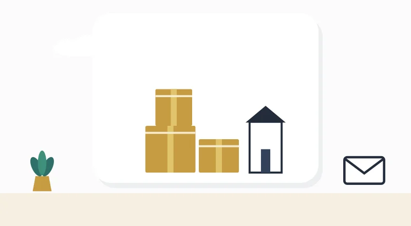 Moving boxes beside a new home